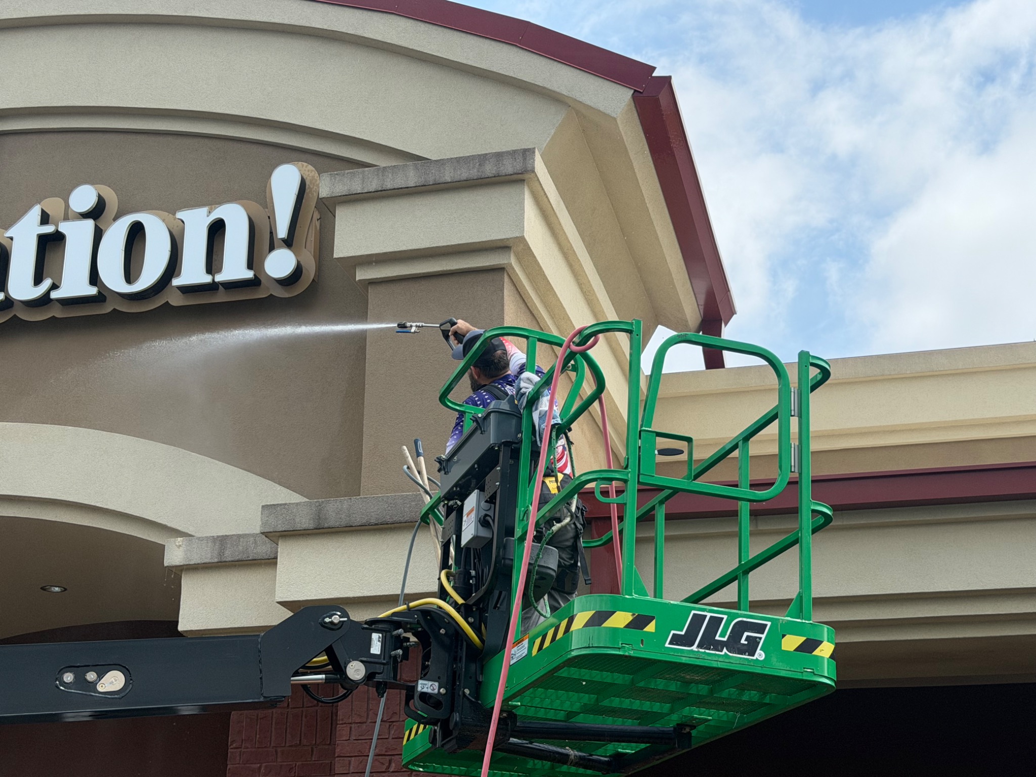 Veterans Vision working from a lift to clean the upper exterior of a Chattanooga church