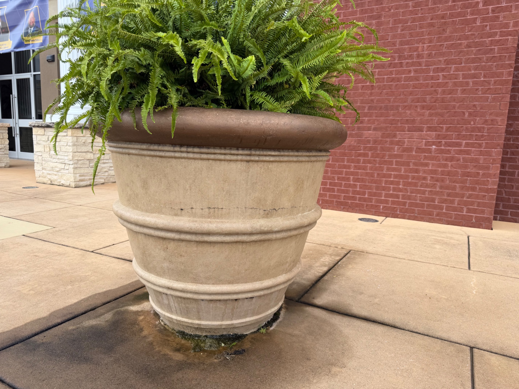 Large planter outside the Chattanooga church with buildup around its lower edge before cleaning